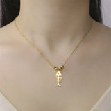Collier Poisson Squelette Doré à Billes porté autour du cou, mettant en avant les perles dorées et le pendentif ajouré.