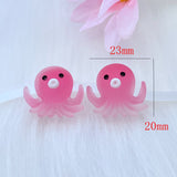 Deux figurines Poulpe en résine rose, mesurant environ 23 mm x 20 mm, présentées sur fond blanc pour illustrer leurs dimensions.
